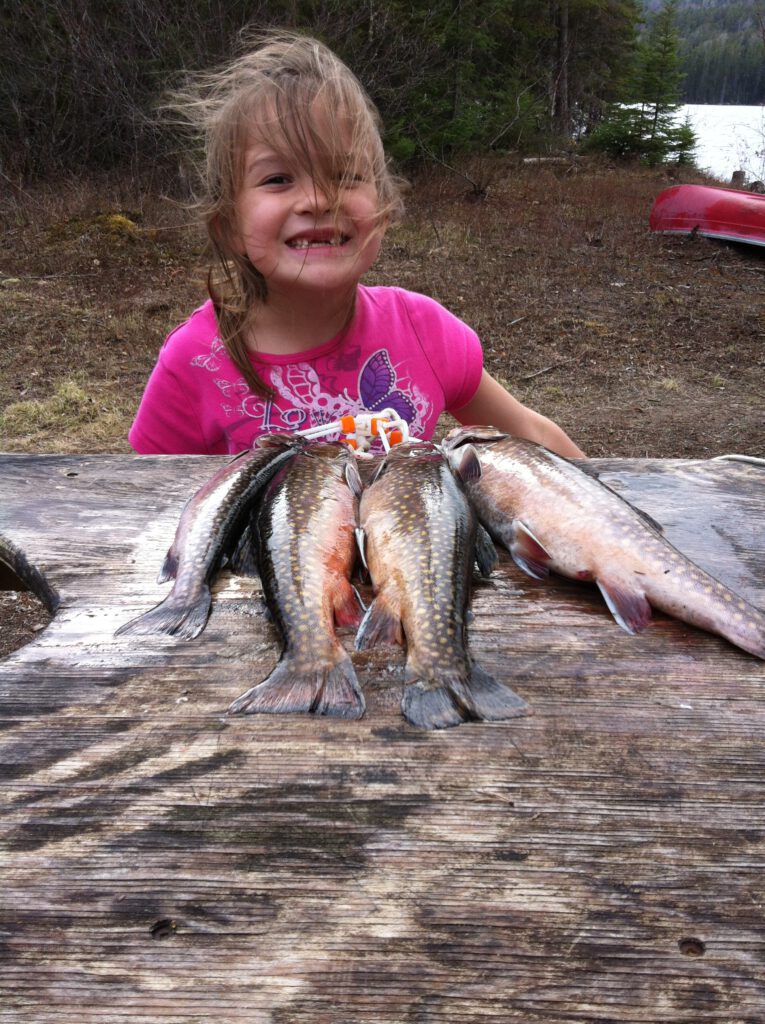 A little girl showing off the fish she caught at McCrea.